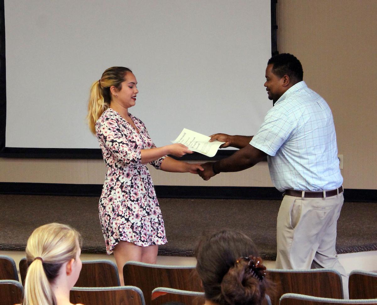 A Family and Consumer Sciences student receives an award at a reception.