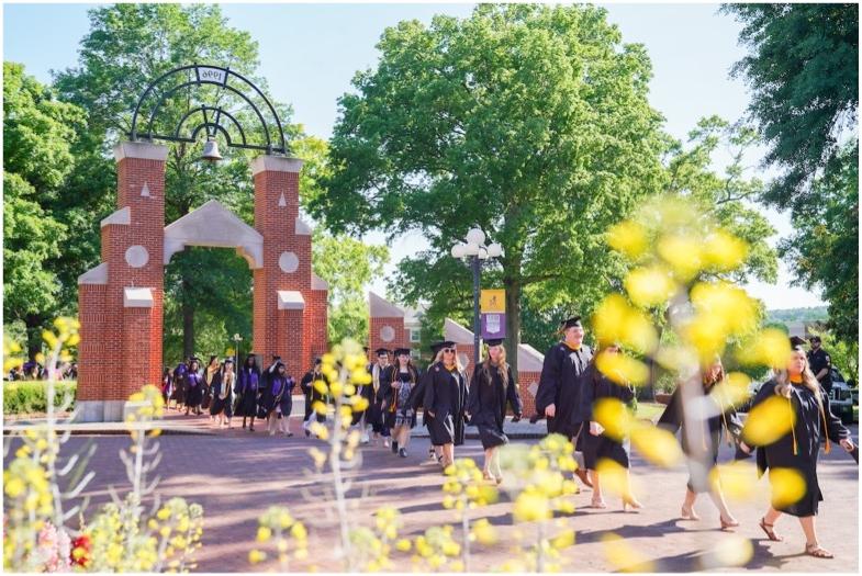 University of Montevallo spring graduates walk from the quad to Flowerhill for Commencement.