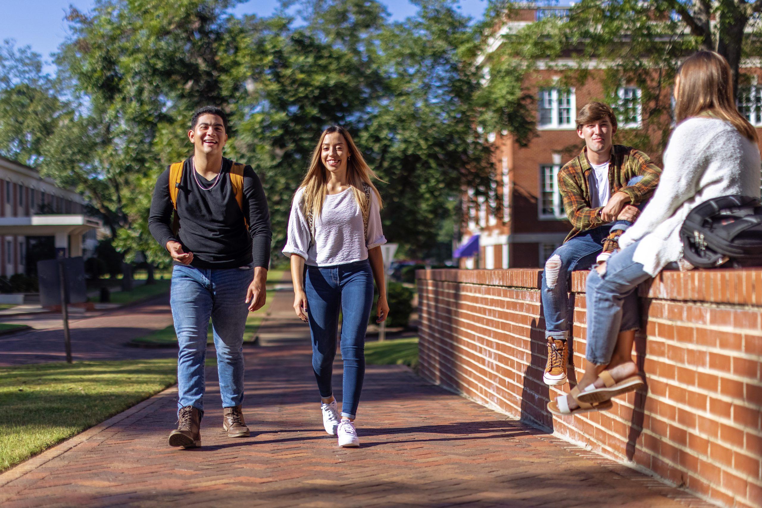 University of Montevallo students walk along a brick street on campus.
